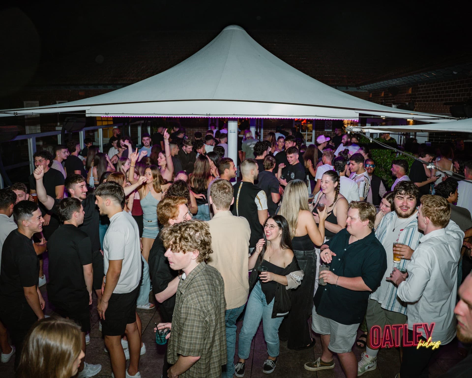 A packed dance floor under the marquee at Oatley Fridays
